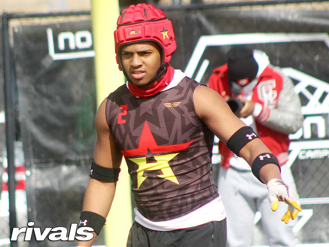 Rivals100 defensive back Bryce Anderson holds a Michigan Wolverines football recruiting offeer. 