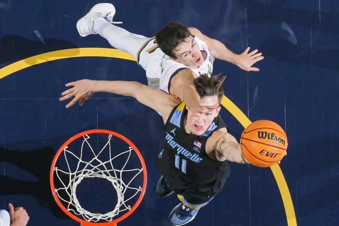Marquette's Tyler Kolek (11) grabs a rebound in front of Notre Dame's Cormac Ryan (5), Sunday at Purcell Pavilion.