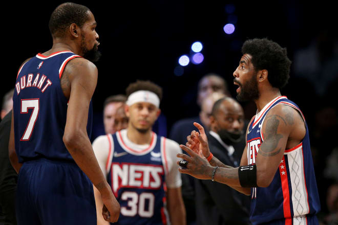 Brooklyn Nets guard Kyrie Irving (11) talks to forward Kevin Durant (7) during the fourth quarter of game four of the first round of the 2022 NBA playoffs against the Boston Celtics at Barclays Center. The Celtics defeated the Nets 116-112 to win the best of seven series 4-0. Mandatory Credit: Brad Penner-USA TODAY Sports