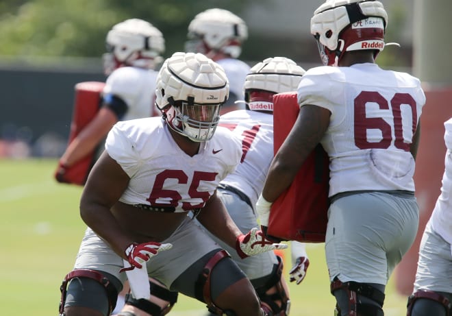 Offensive lineman JC Latham (65) works against offensive lineman Kendall Randolph (60) as Crimson Tide players work on drills in practice Monday, Aug. 9, 2021. Photo | Gary Cosby Jr. via Imagn Content Services, LLC