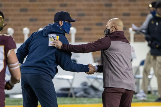 Michigan Wolverines football head coach Jim Harbaugh and Minnesota head coach P.J. Fleck shake hands