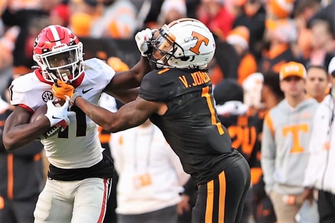 Tennessee's Velus Jones attempts to tackle Derion Kendrick after the Georgia cornerback intercepted a pass. It was one of two turnovers committed by the Volunteers.