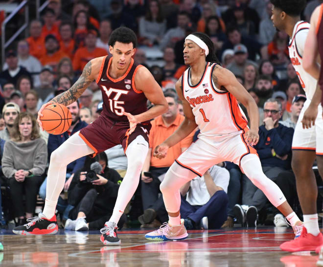 Maliq Brown, right, defends Virginia Tech's Lynn Kidd during a game this past season. 