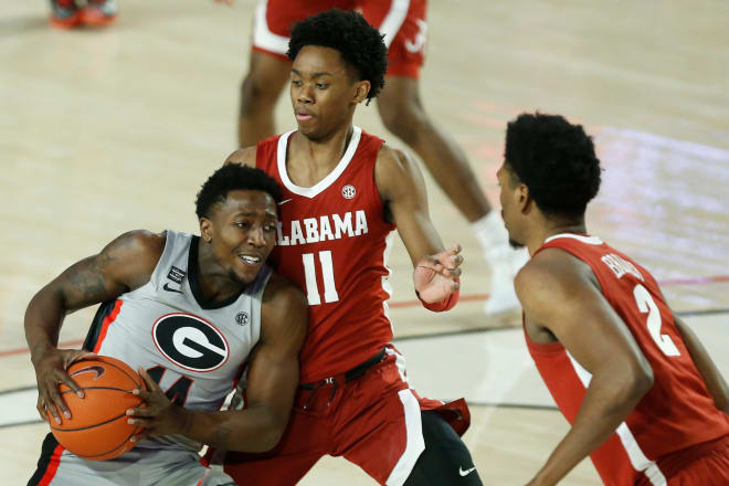 Georgia's Tye Fagan (14) tries to get past Alabama guard Joshua Primo (11) and Alabama forward Jordan Bruner (2) during an NCAA basketball game between Alabama and Georgia in Athens, Ga., on Saturday, March 6, 2021. Mandatory Credit: Joshua L. Jones-USA TODAY Sports