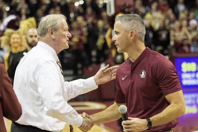 FSU President John Thrasher congratulates new football coach Mike Norvell during an appearance a Florida State basketball game Sunday afternoon.