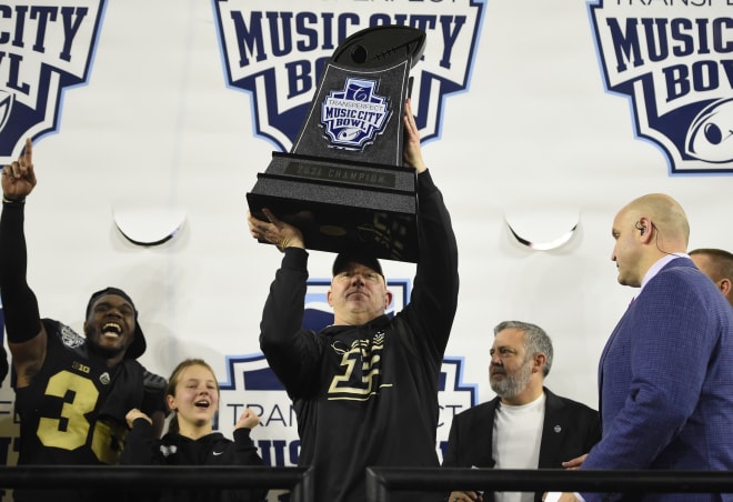 Coach Jeff Brohm hoists the trophy after the incredible Purdue victory over Tennessee.