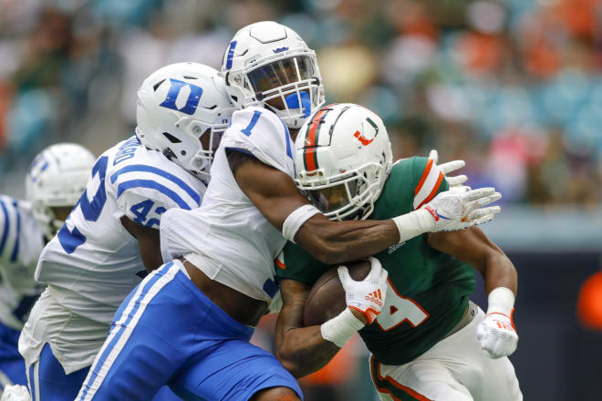 Darius Joiner, left, tackles Miami's Jaylan Knighton during a game last season. 