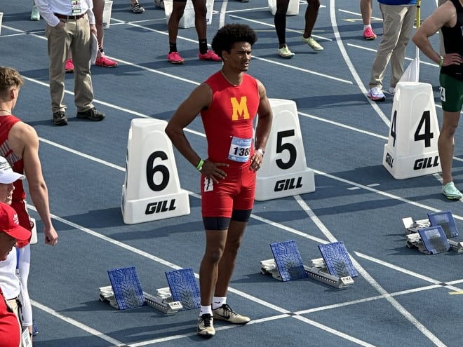 2024 Iowa signee Alex Mota waits at the start line for the beginning of the 100 meter dash. 