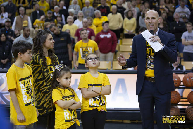Brad Loos addressed the crowd at halftime as his wife, Jen, and their three children stood by his side
