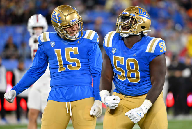  UCLA Bruins linebacker Laiatu Latu (15) and defensive lineman Gary Smith III (58) celebrate after a sack of Stanford Cardinal quarterback Tanner McKee in the first half at the Rose Bowl.