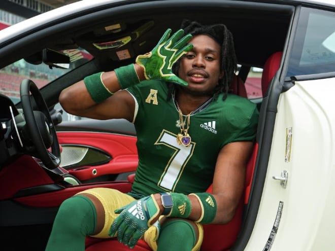 Isaac poses in a Maserati on the field at Raymond James Stadium last week during his OV 