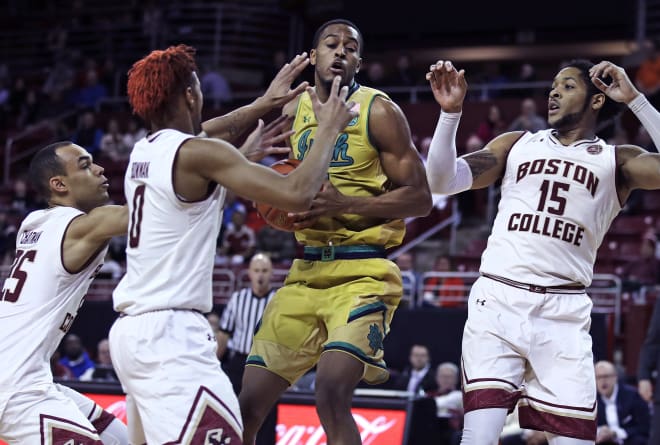 Notre Dame forward V.J. Beachem (center) is surrounded on a drive to the basket against Boston College.
