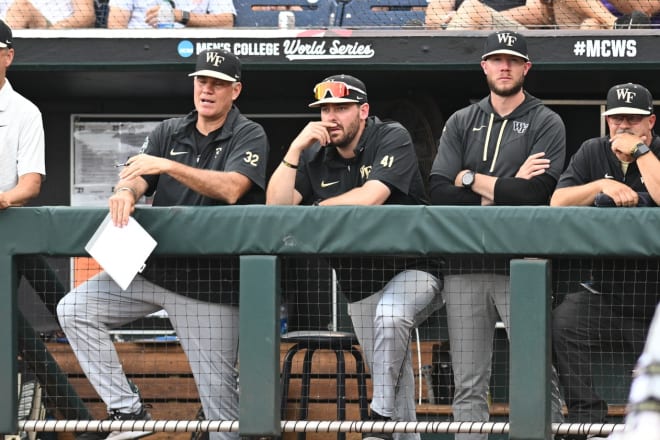 Wake Forest coach Tom Walter, left, talks with his staff during last year's College World Series. 