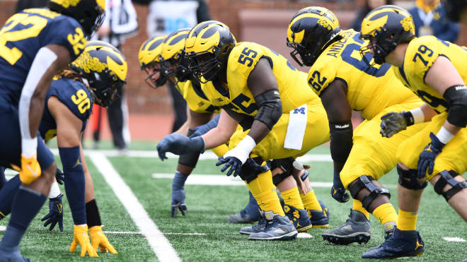 Olu Oluwatimi lines up at center in Michigan's 2022 spring game. (Photo via MGoBlue.com/Michigan Athletics)