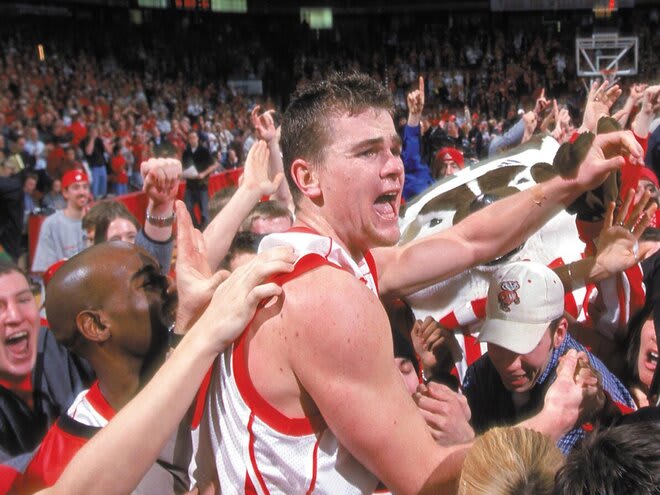 Kirk Penney is mobbed by UW fans following Wisconsin's victory over Michigan, clinching a share of the 2002 Big Ten title.