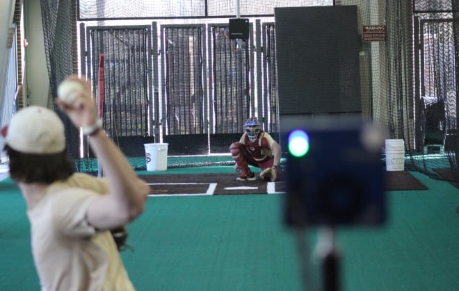 Jamie Arnold throws with the Trackman (behind catcher) and Edgertronic camera watching.