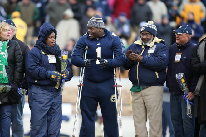 Notre Dame Fighting Irish football defensive tackle Louis Nix III with his parents on Senior Day in 2013