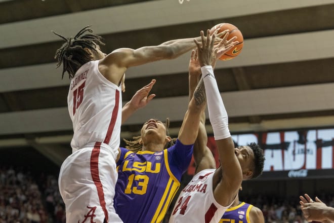 LSU Tigers forward Jalen Reed (13) shoots the ball against Alabama Crimson Tide forward Noah Clowney (15) and forward Brandon Miller (24) during the first half at Coleman Coliseum. Photo | Marvin Gentry-USA TODAY Sports