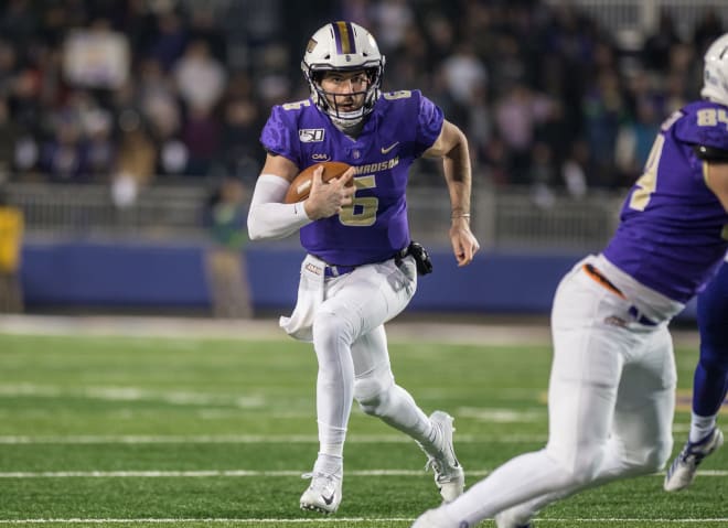 James Madison quarterback Ben DiNucci carries the ball during the Dukes' win over Weber State in the semifinals of the FCS playoffs last month at Bridgeforth Stadium.