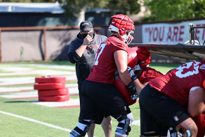 Offensive line coach Terry Heffernan works with the Cardinal linemen during a spring practice.