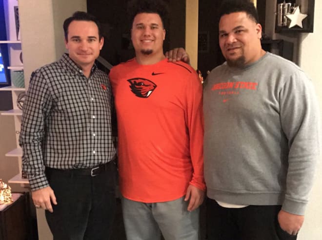 Jonathan Smith with Isaac Hodgins and his father during a home visit on December 5