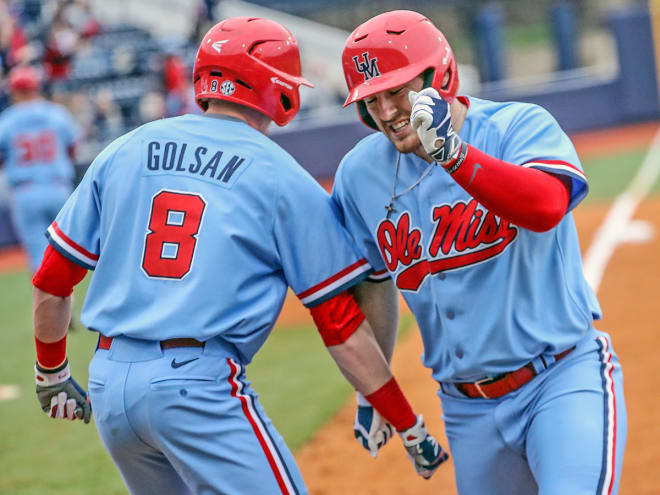 Thomas Dillard (right) is congratulated by Will Golsan following a home run. 