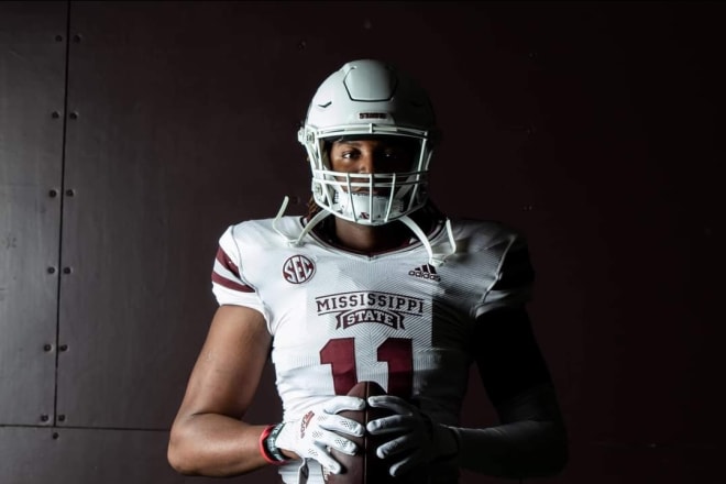 Moore poses in a Mississippi State uniform during a visit