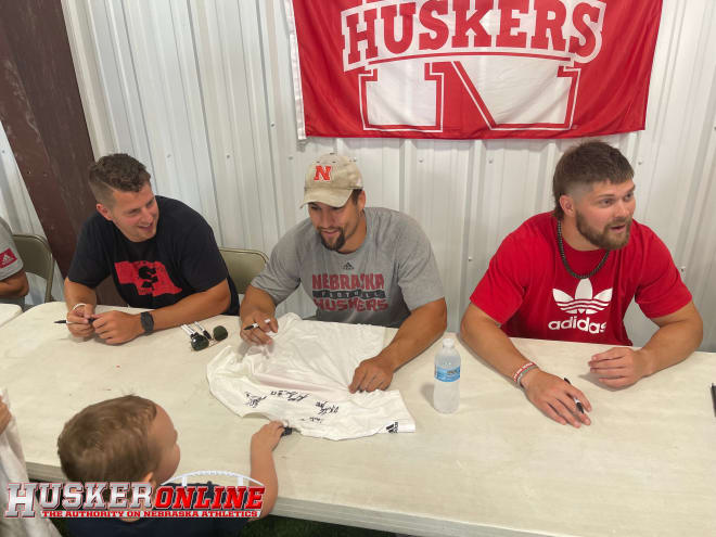 Former Huskers Brandon Reilly, Josh Banderas and Nate Gerry sign autographs in Greeley on Friday. 