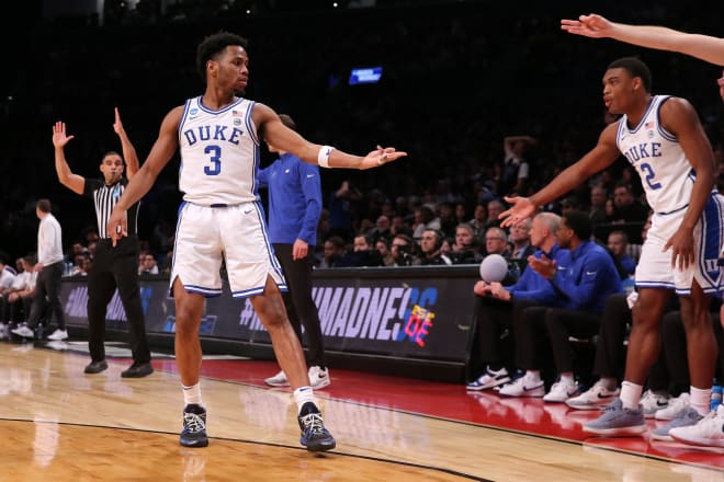 Jeremy Roach celebrates with Duke's bench after making a shot in the second half. 