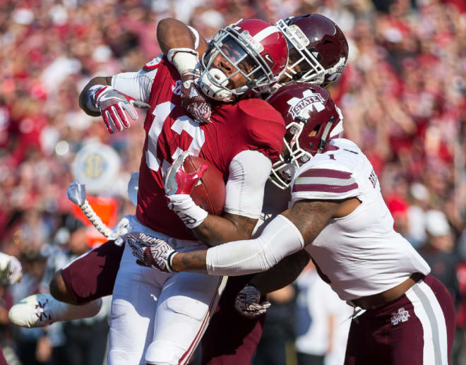 Alabama wide receiver ArDarius Stewart (13) hauls in a touchdown along with defenders during the Mississippi State-Alabama game on Saturday, Nov. 12, 2016, at Bryant-Denny Stadium in Tuscaloosa, Ala.