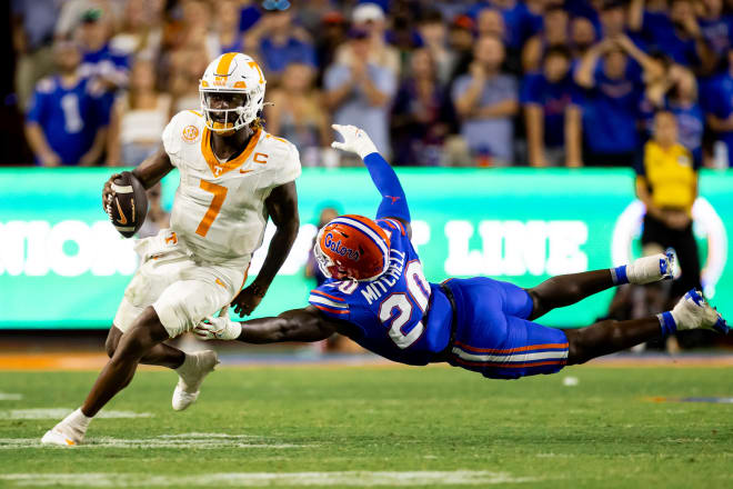 Sep 16, 2023; Gainesville, Florida, USA; Florida Gators linebacker Teradja Mitchell (20) attempts to tackle Tennessee Volunteers quarterback Joe Milton III (7) during the second half at Ben Hill Griffin Stadium.