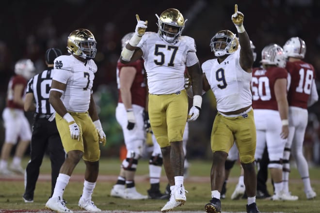 Defensive tackle Jayson Ademilola (57) and defensive end Justin Ademilola (9) have announced they will return to Notre Dame for a fifth season. Junior defensive end Isaiah Foskey (7) hadn't announced his decision as of Friday morning.