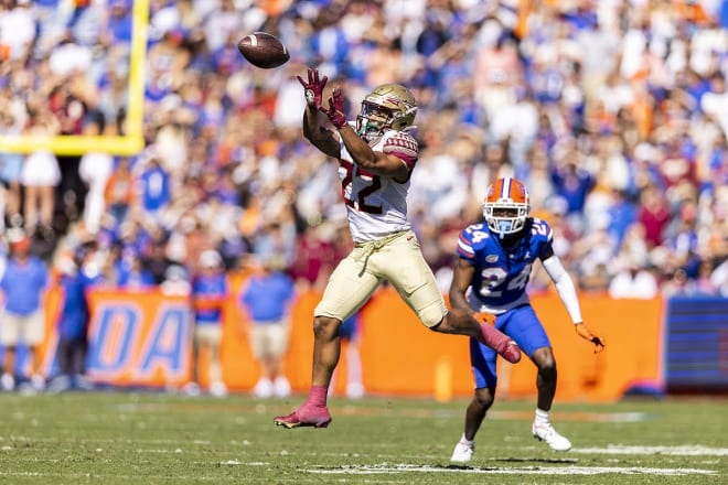 FSU receiver Ja'Khi Douglas leaps to make a catch Saturday at Florida.