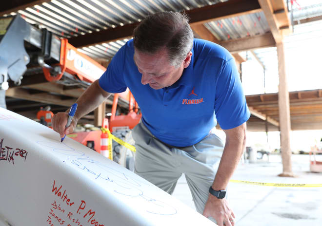 Dan Mullen signs the final beam before it's placed at the James W. “Bill” Heavener Football Training Center