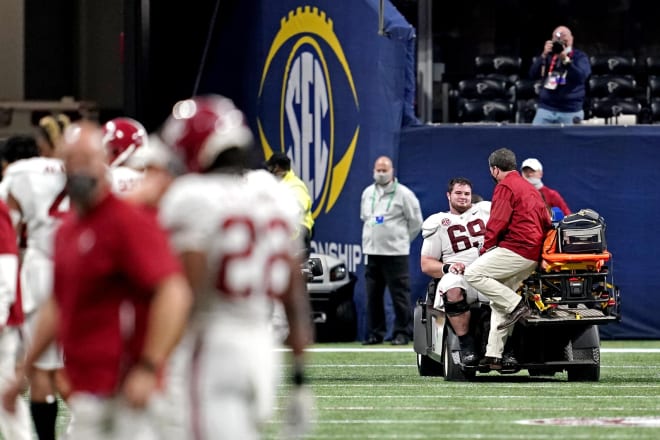 Alabama Crimson Tide offensive lineman Landon Dickerson (69) is taken off the field after an injury during the fourth quarter against the Florida Gators in the SEC Championship at Mercedes-Benz Stadium. Photo | Imagn