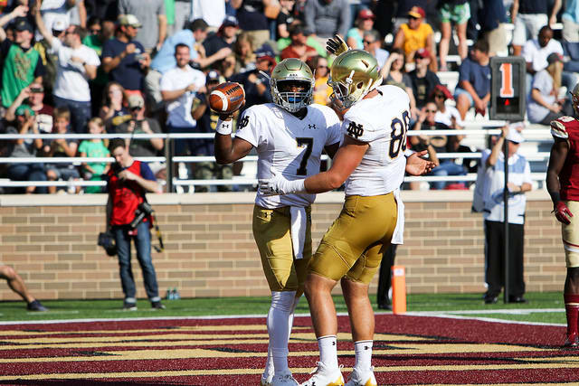 Brandon Wimbush set a Notre Dame quarterback rushing record with 207 yards and four touchdowns in the 49-20 win at Boston College.