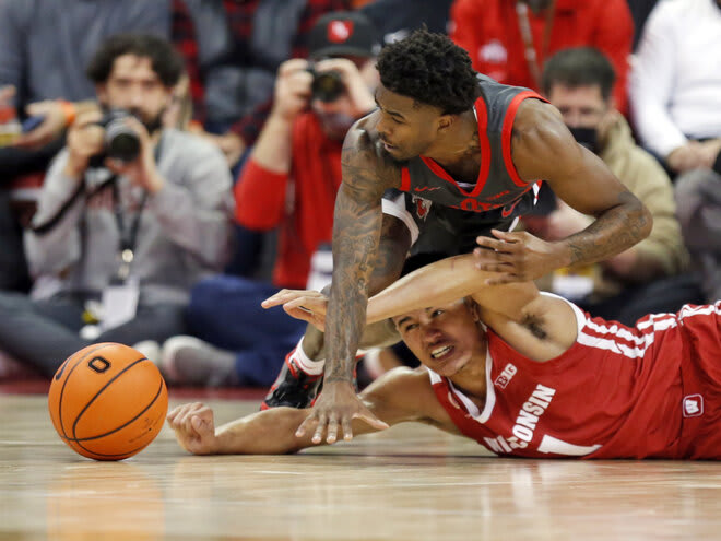 Ohio State guard Jamari Wheeler, top, and Wisconsin guard Jonathan Davis work for a loose ball during the first half