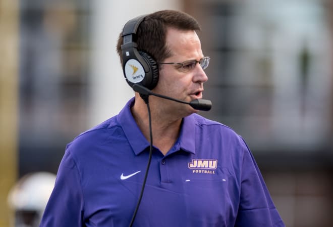 James Madison coach Curt Cignetti talks on his headset during the Dukes' win over St. Francis earlier this season at Bridgeforth Stadium.