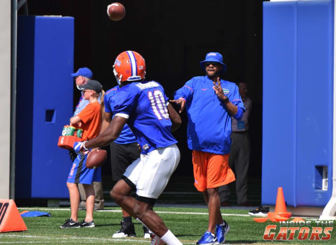 Wide receivers coach Kerry Dixon II throws a pass to sophomore wideout Joshua Hammond