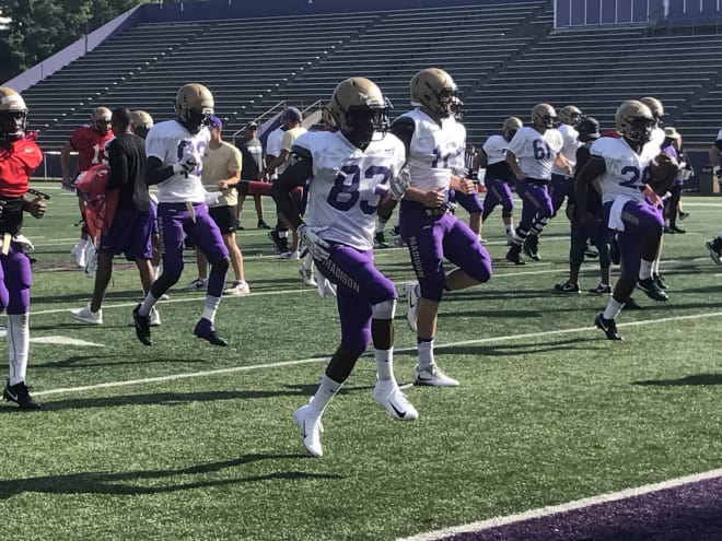 James Madison wide receiver Josh Sims (83) warms up before Saturday's scrimmage
