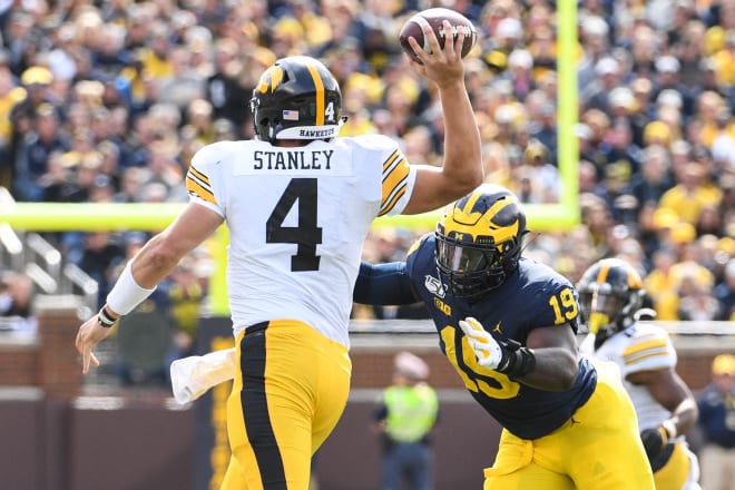 Junior defensive end Kwity Paye zeroes in on beleaguered Iowa quarterback Nate Stanley, who the Wolverines sacked eight times and hurried six additional times.
