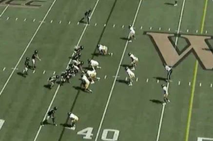 Hartman starts this play about 5 yards behind the line of scrimmage, and his back is to his right.