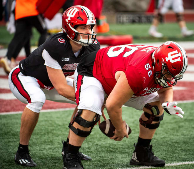 Indiana's Mike Katic (56) hikes the ball to Kurtis Rourke (9) as they work through a drill during practice at Memorial Stadium on Tuesday, March 26, 2024. © Rich Janzaruk/Herald-Times / USA TODAY NETWORK