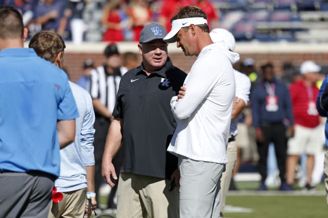 Kentucky Wildcats head coach Mark Stoops (left) and Mississippi Rebels head coach Lane Kiffin (right) talk prior tot the game at Vaught-Hemingway Stadium. Mandatory Credit: Petre Thomas-Imagn Images