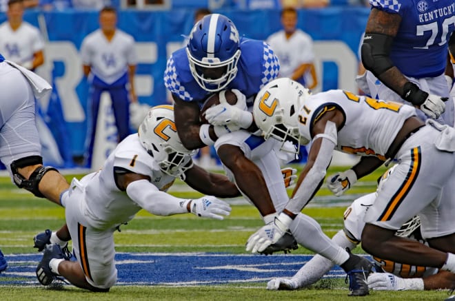 Kentucky running back Kavosiey Smoke tried to split a pair of Chattanooga defenders in Saturday's game at Kroger Field.