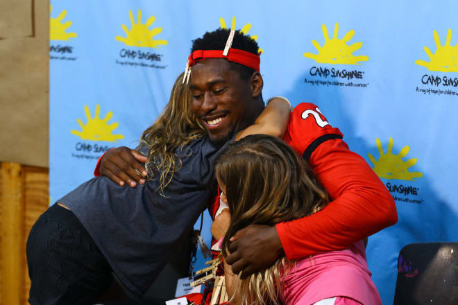 J.R. Reed hugs two campers at Camp Sunshine (photo: UGA Athletics) 