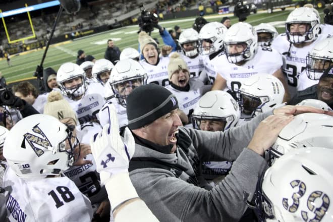 Coach Pat Fitzgerald and the Cats celebrate their Big Ten West title.