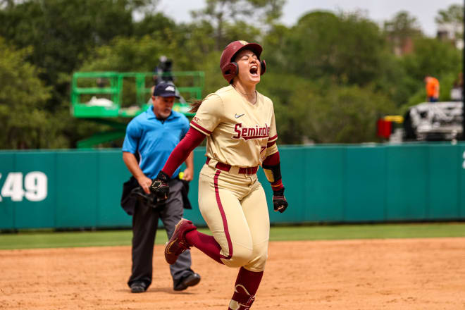 Katie Dack celebrates her ninth home run of the season in Sunday's win.