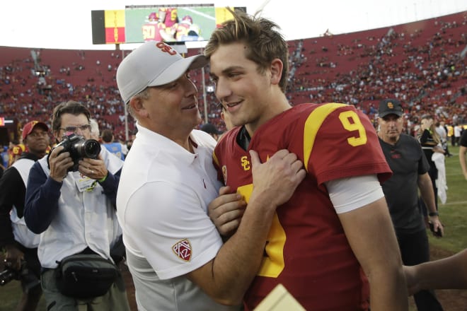 USC coach Clay Helton congratulates QB Kedon Slovis after the freshman passed for a Trojans-record 515 yards and 4 touchdowns.