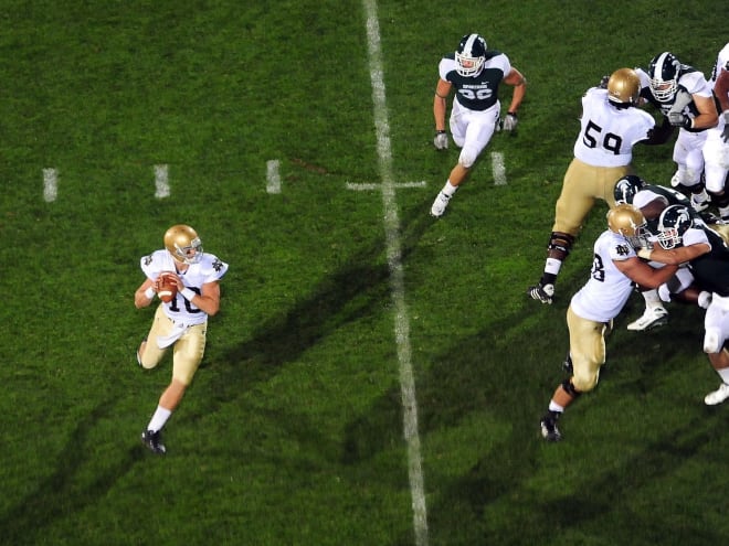 Notre Dame quarterback Dayne Crist, left, prepares to throw a touchdown pass at Michigan State in 2010.